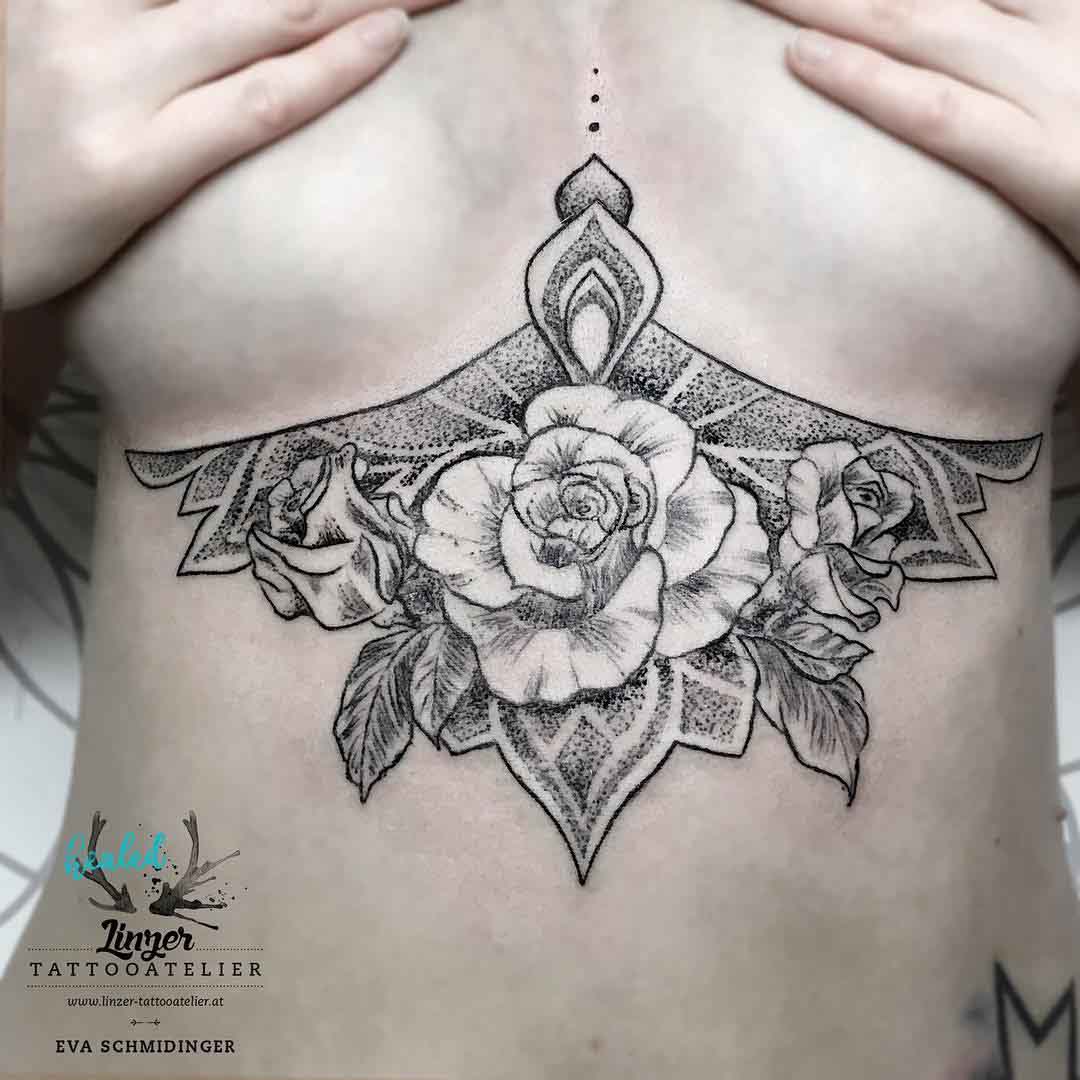 under breasts tattoo of rose